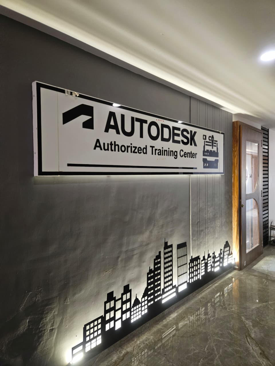 Autodesk Authorized Training Center entrance sign on the wall at Mechman Solution in Vadodara, Gujarat.
